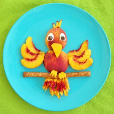 Peach Parrot Fruit Snack on a blue plate