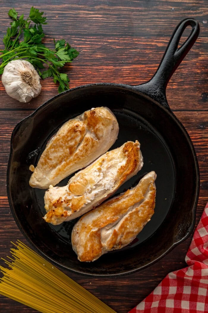 Seared chicken breasts in a skillet