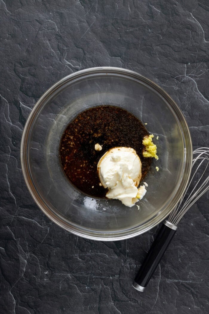 Whisking soy sauce, mayo, and other ingredinets