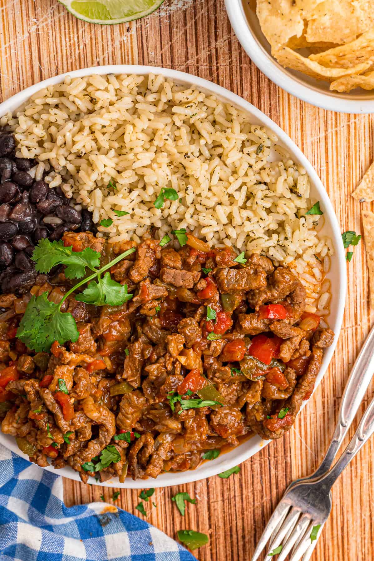 A plate of carne picada with rice and black beans