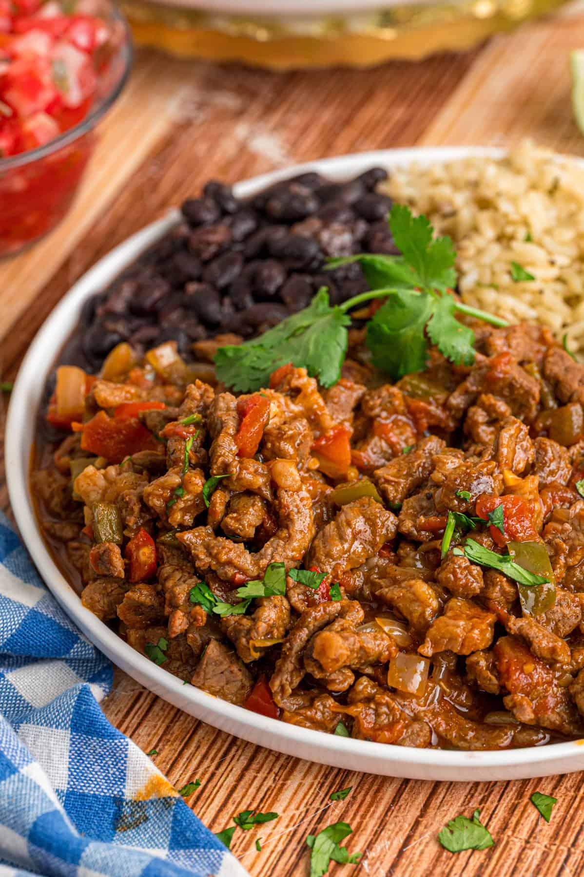 A plate of carne picada with black beans and rice