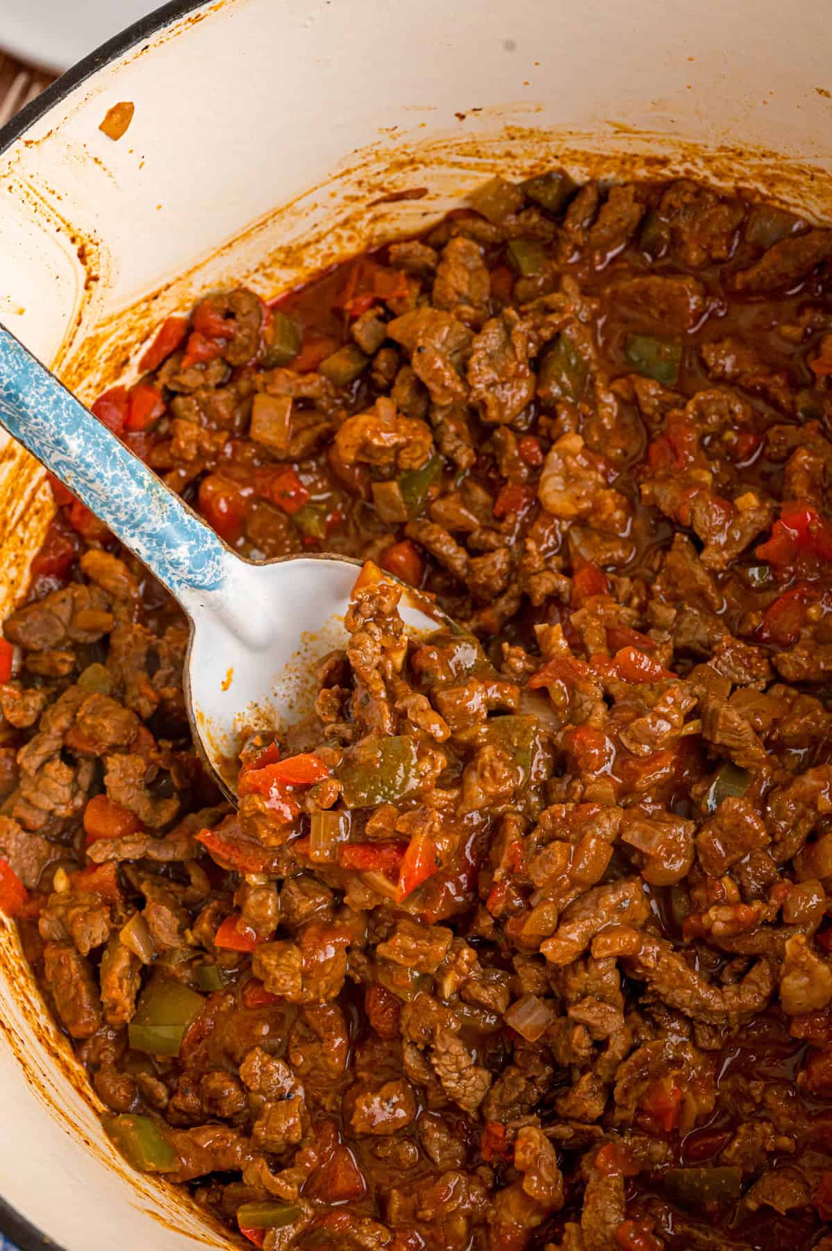A spoon in a bowl of carne picada