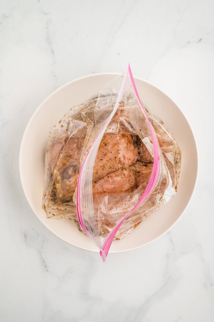 Chicken marinating in a ziploc bag