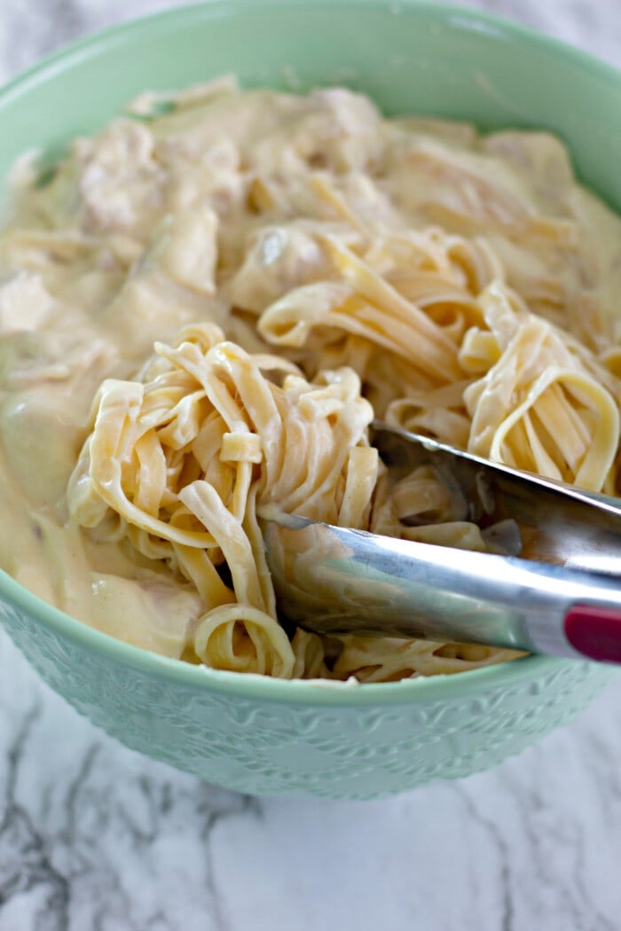 mixing pasta with cream 