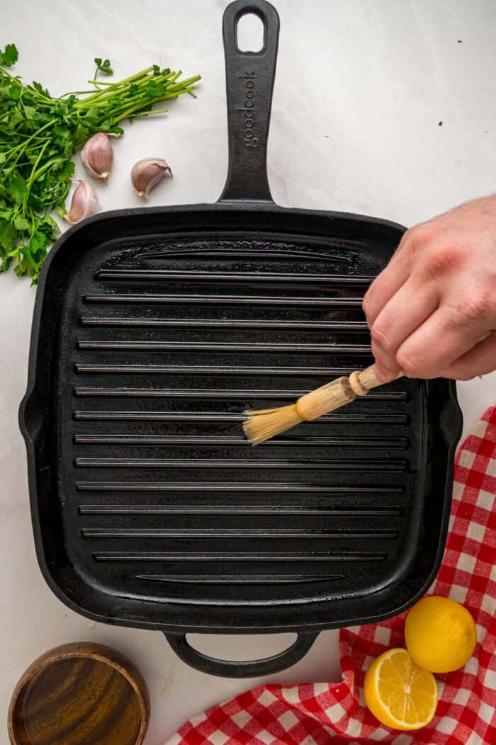 Brushing a grill pan with oil