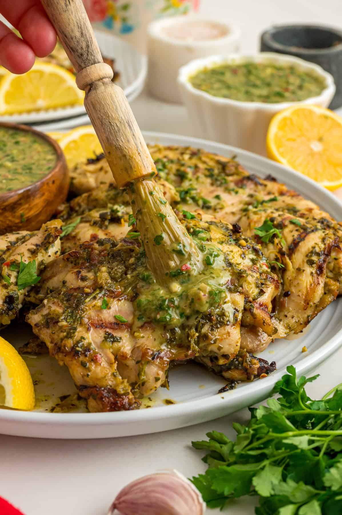 Basting chimichurri chicken