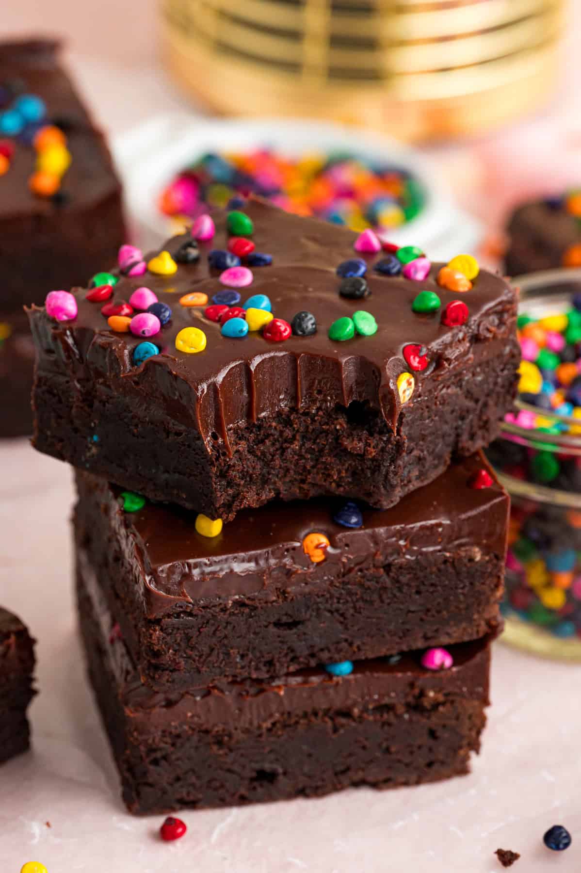 A stack of three cosmic brownies, one with a bite missing