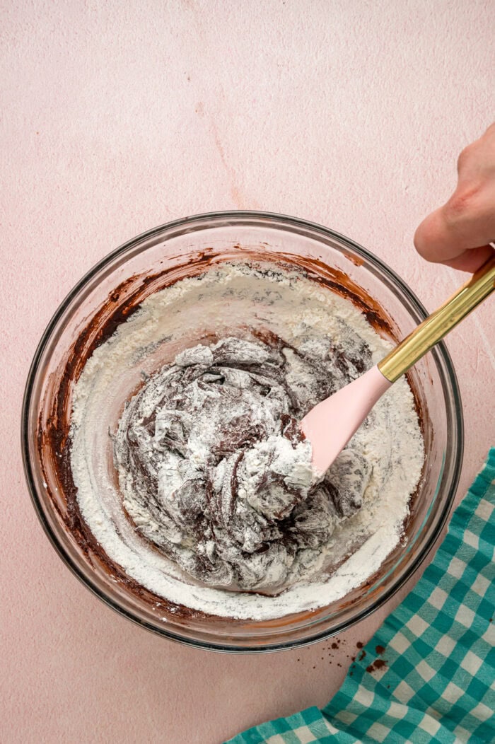 Stirring flour into brownie batter