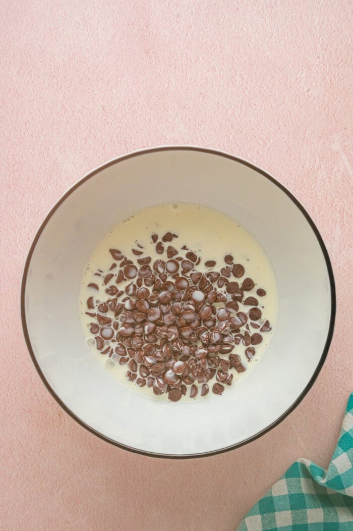 Chocolate chips and heavy cream in a bowl