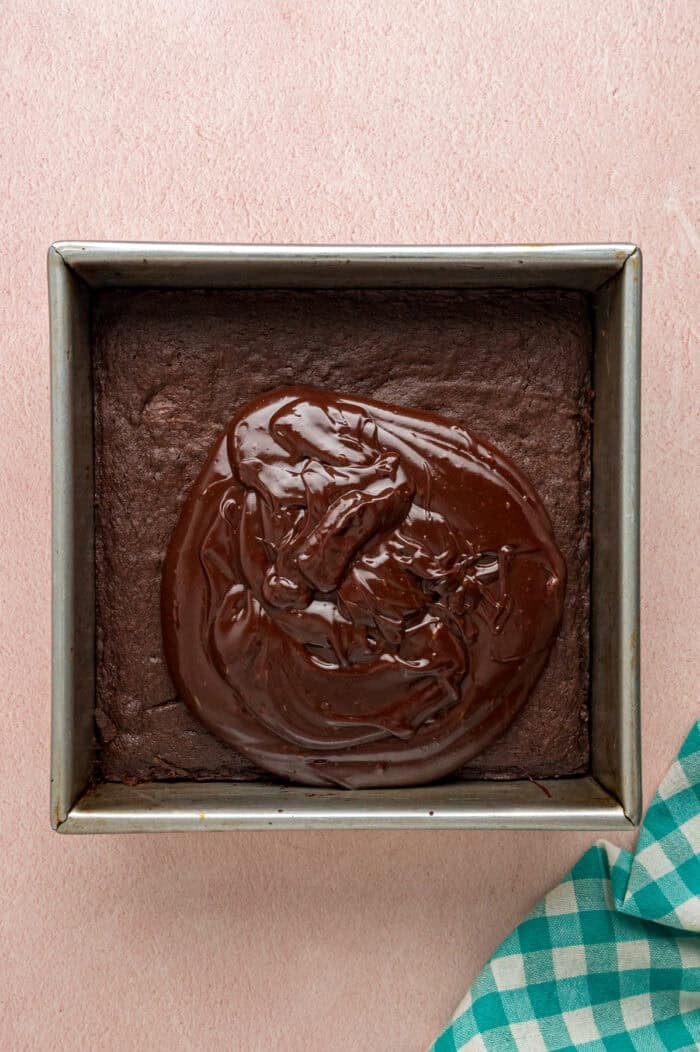 Spreading chocolate frosting on brownies