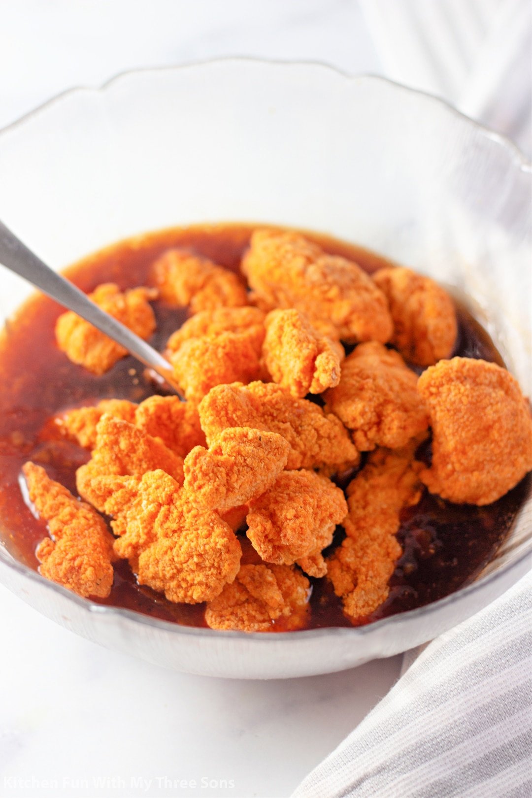 adding nuggets to the sauce.