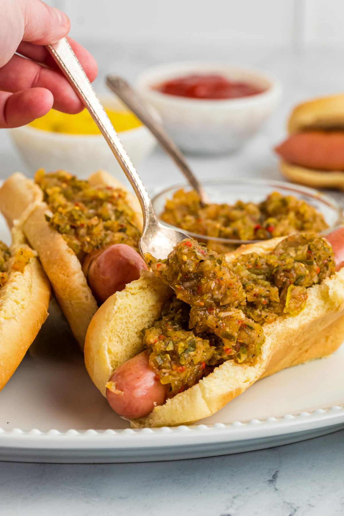 spoonful of hot dog relish on hot dog