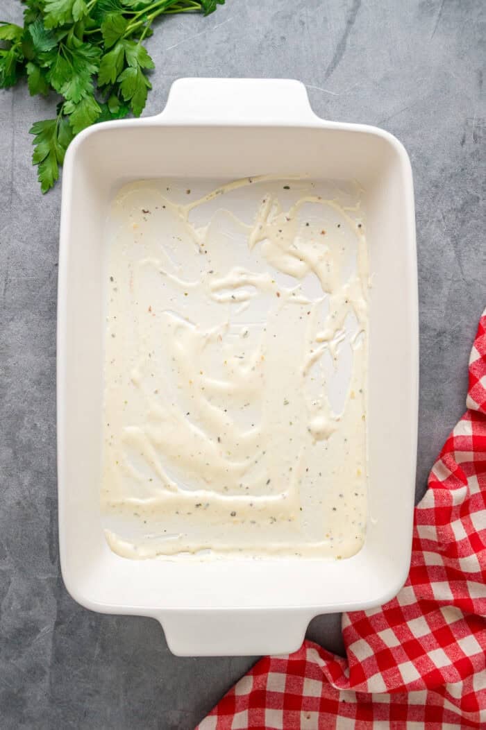 Cream sauce spread in the bottom of a pan