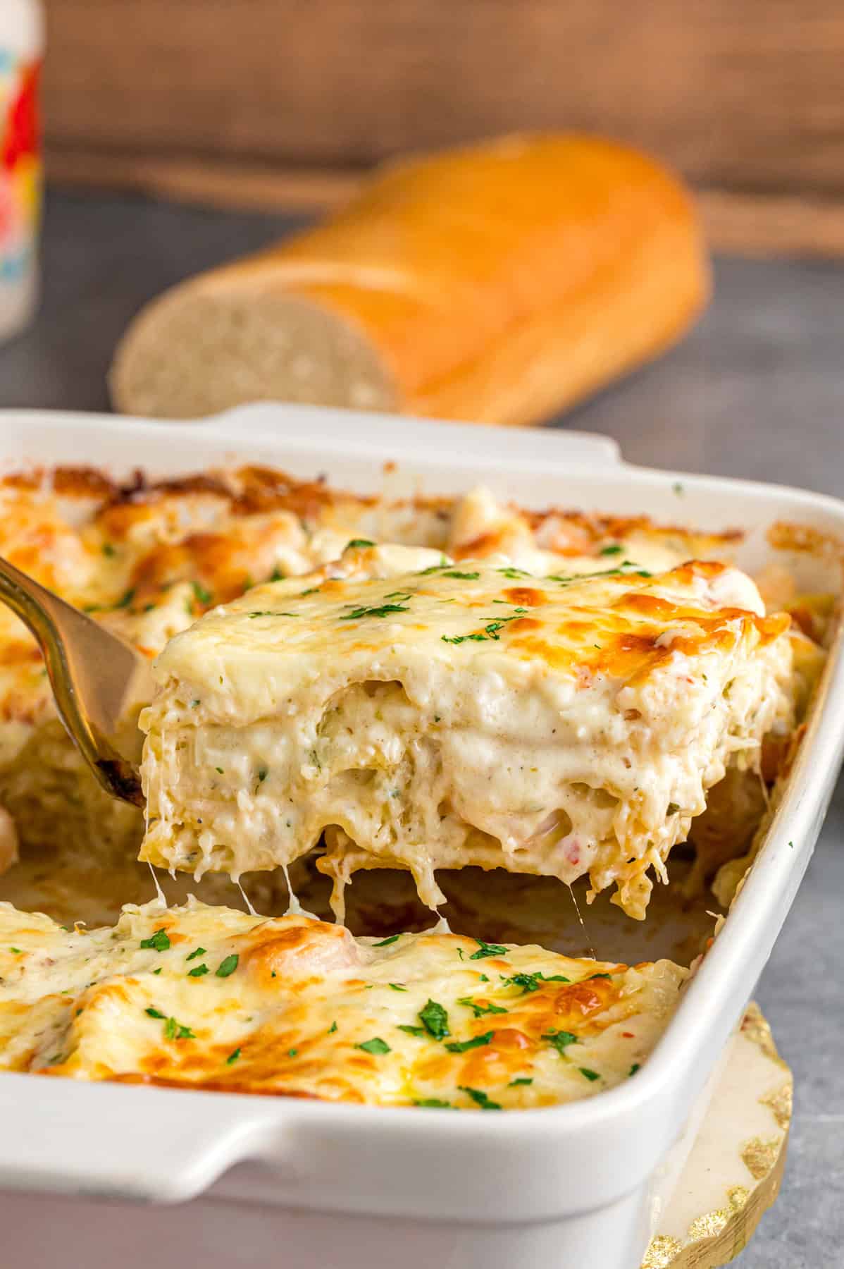 Serving a slice of seafood lasagna