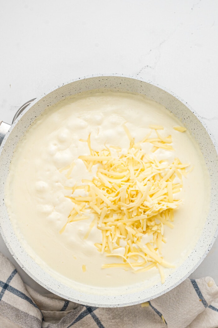 making the cream sauce topped with cheese