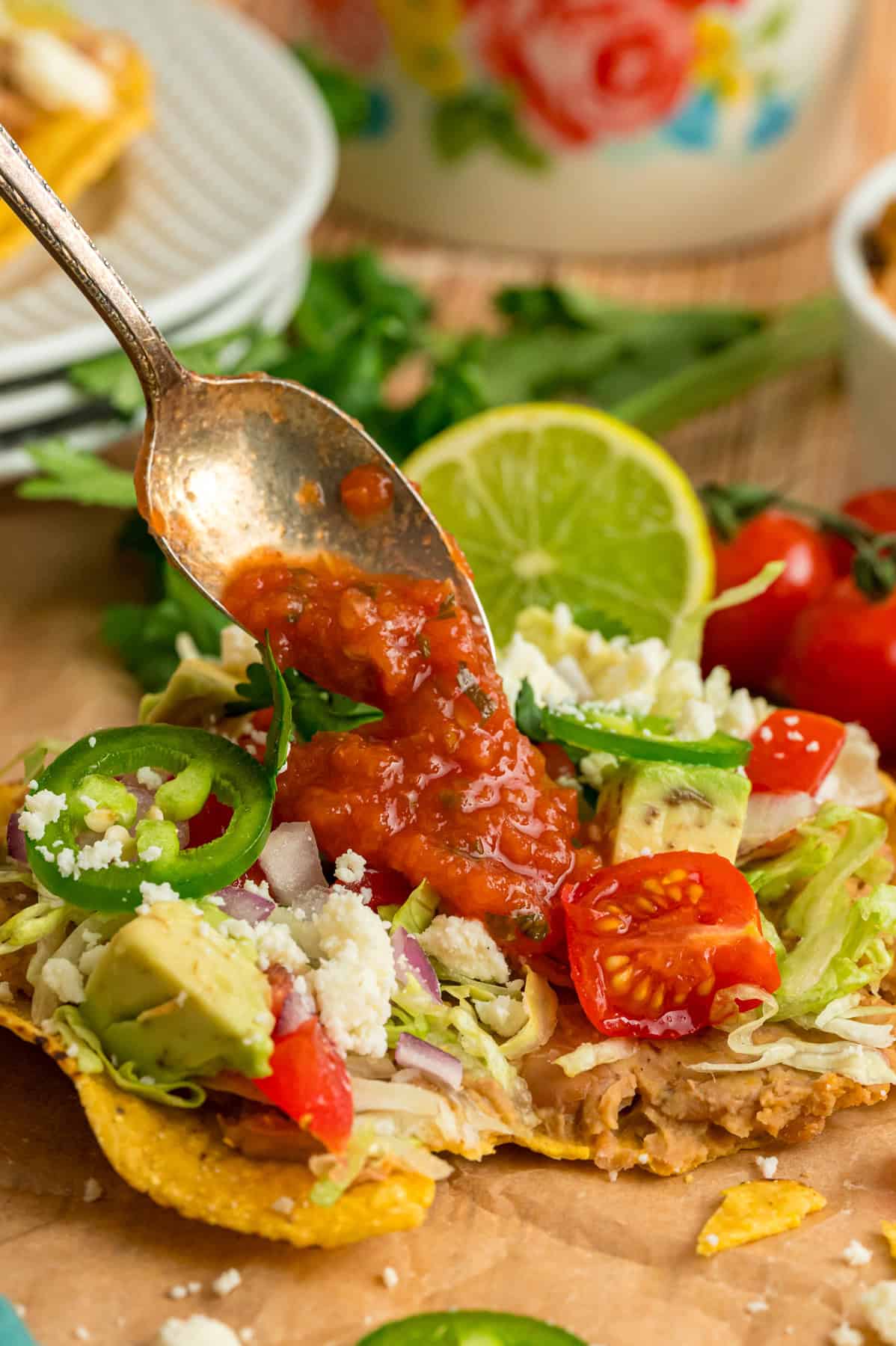 Spooning salsa over an easy tostada recipe